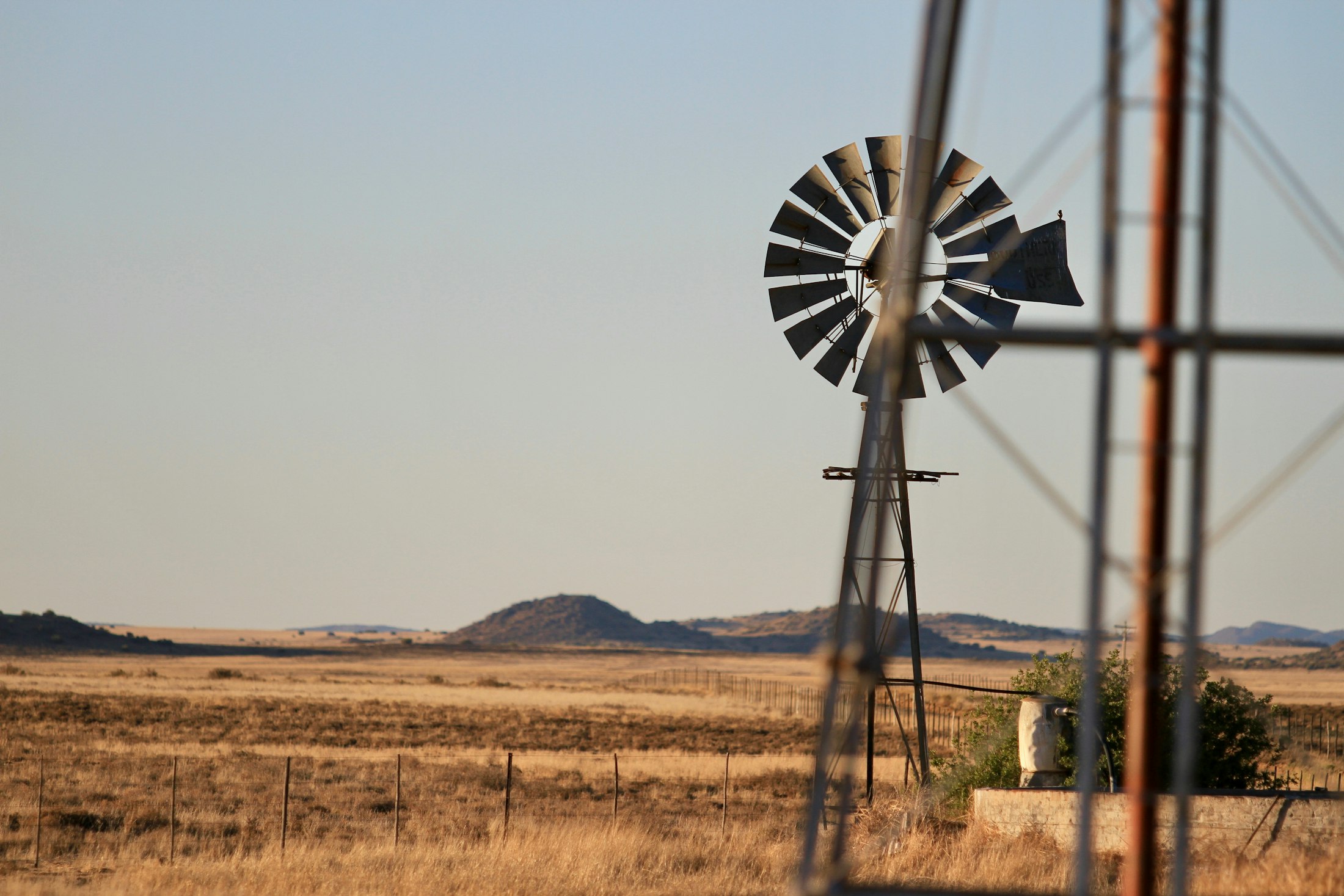 A windmill on the open Karoo plains at dusk