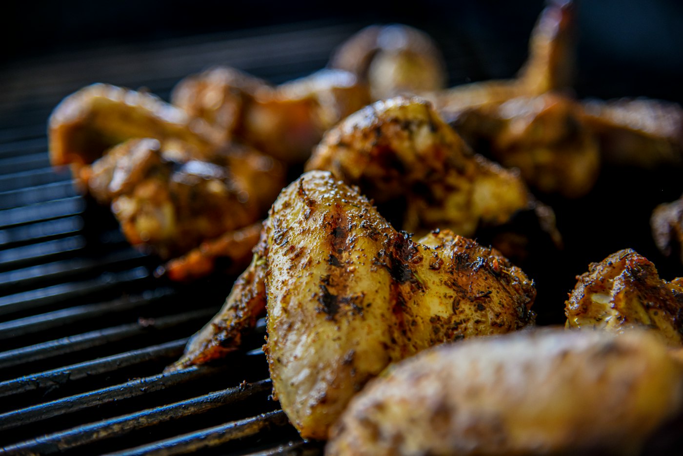 Charred chicken wings on a grill