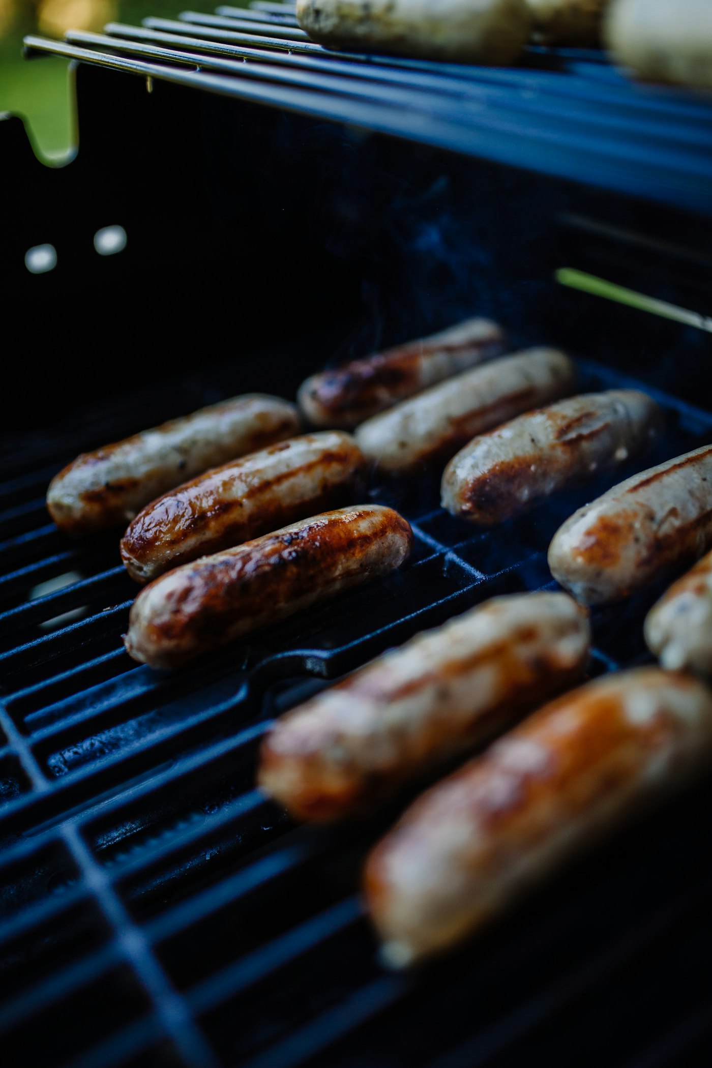 Coils of boerewors browning on a braai grid