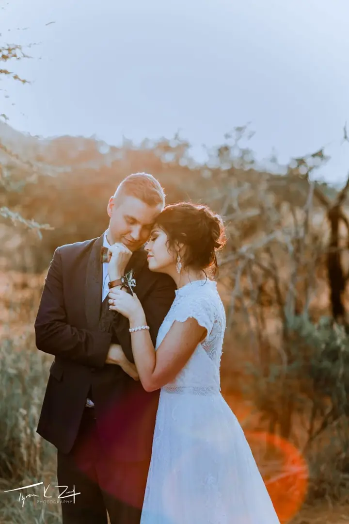 A couple at sunset among the trees