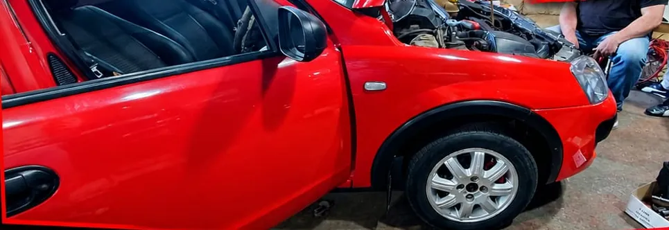 Red Corsa bakkie in the Rico's Sound workshop before its air suspension fitment