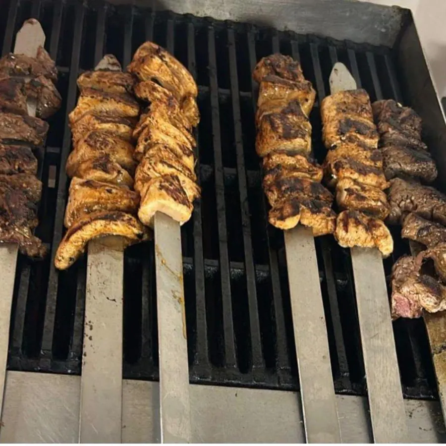 Beef and chicken fillet kebab skewers on a hot grill