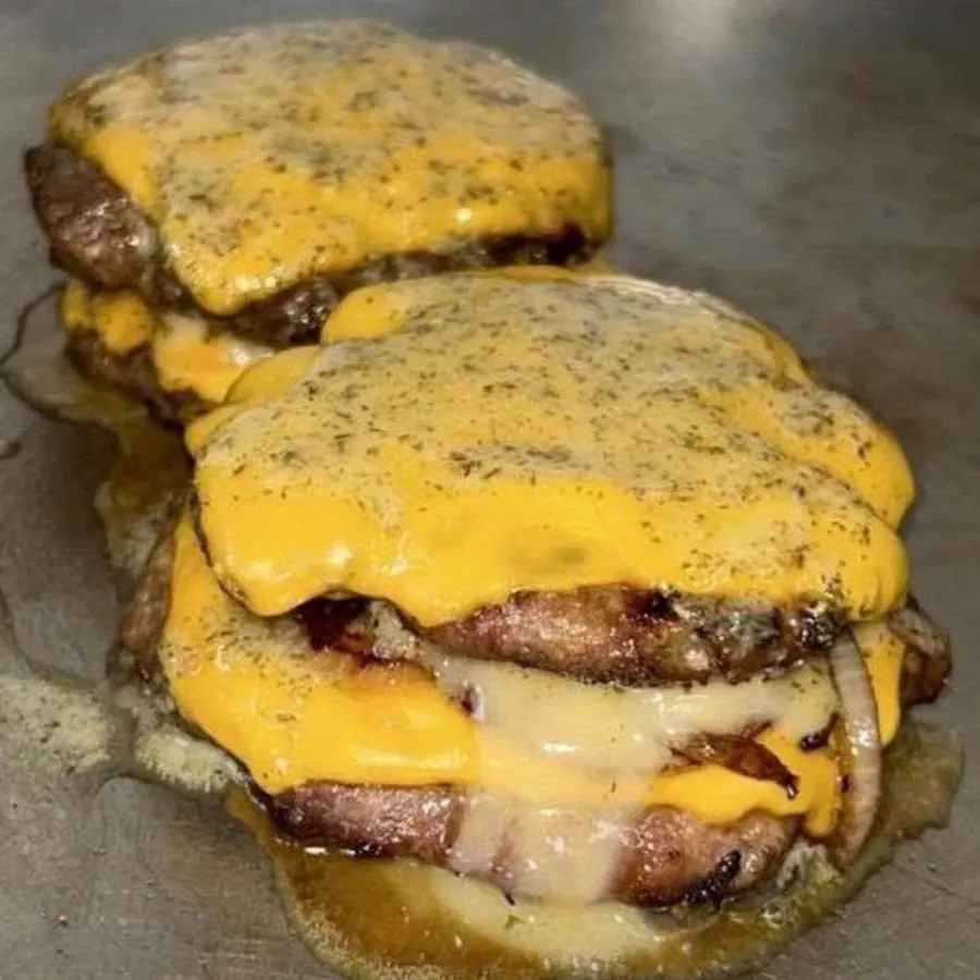 A double smash burger with melted cheddar and caramelised onions